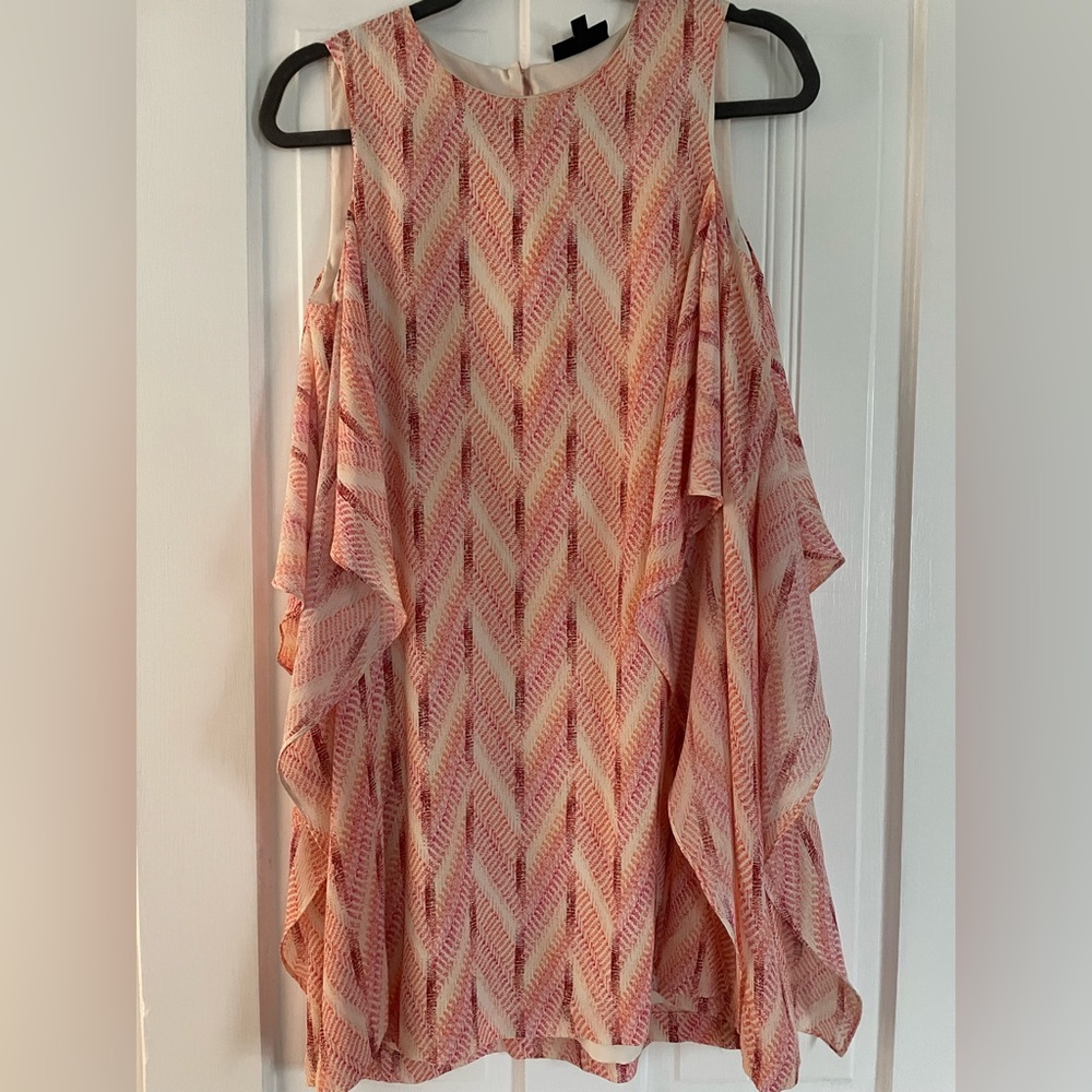 Pink float dress with flowy ruffle detail down the sides
